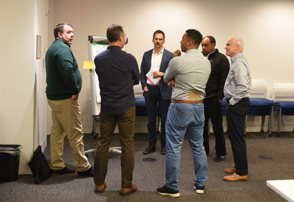 Kevin Bolen of KPMG (at left) leads a breakout discussion on measuring innovation ROI.