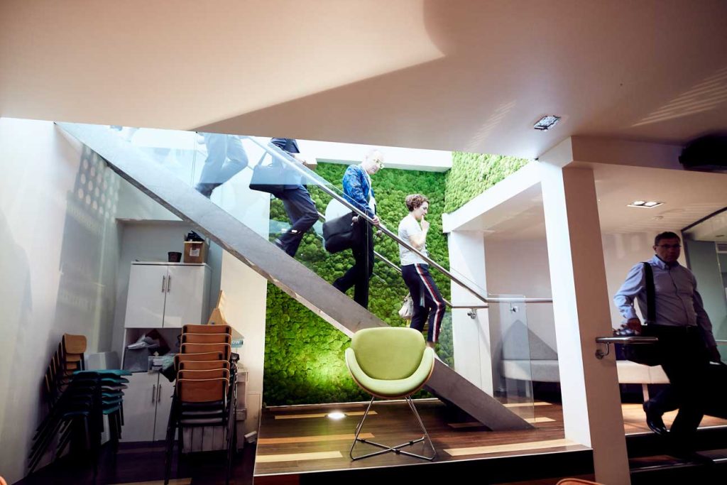 The group descends a staircase at IDEALondon, a shared startup space operated by Cisco.