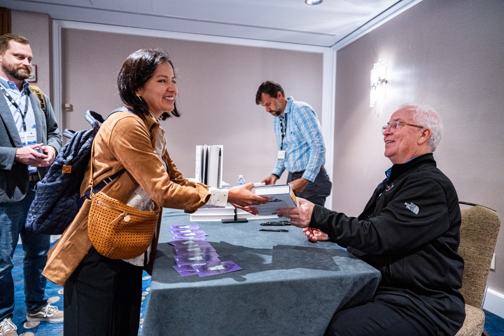 Bob Weis signs copies of his book “Dream Chasing.”
