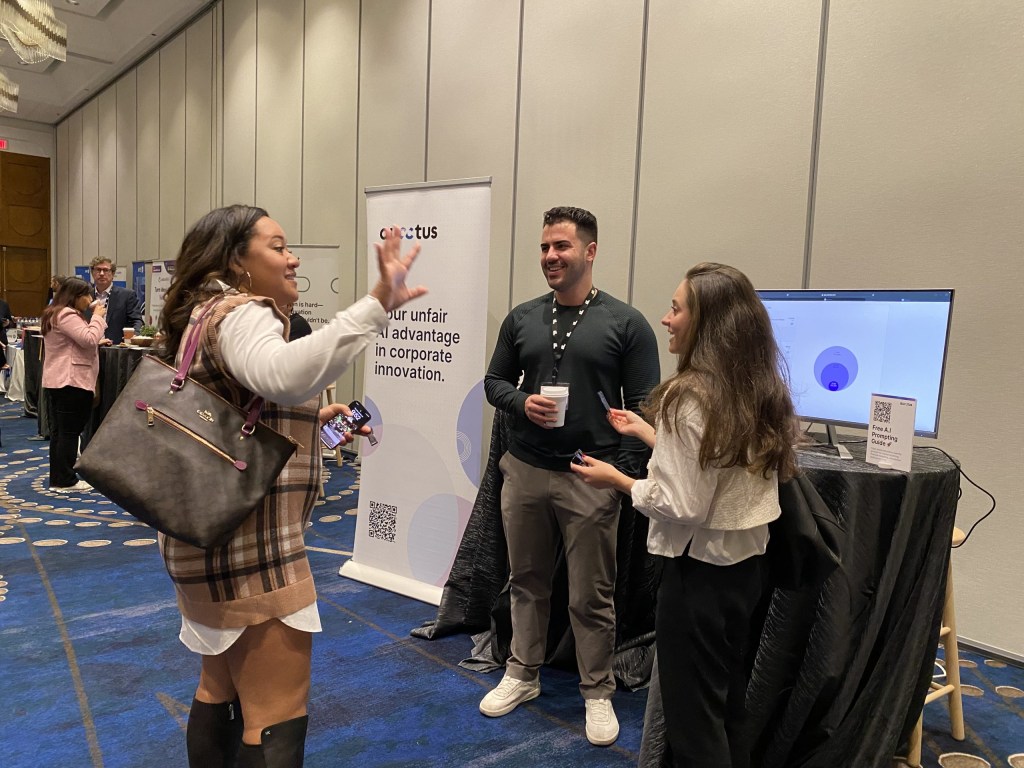 Vincent Atallah talks with participants at the Aucctus table