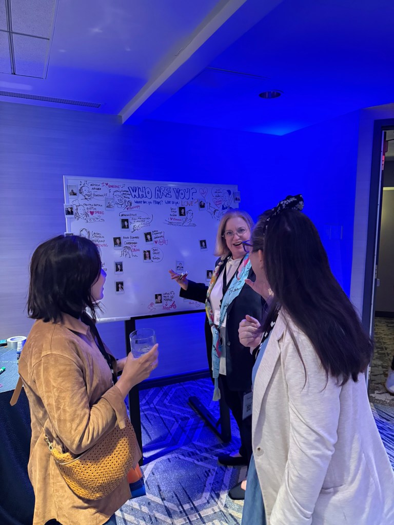 LIsa Rothstein of Drawing Out Your Genius creates sketches on the Impact “welcome board”
