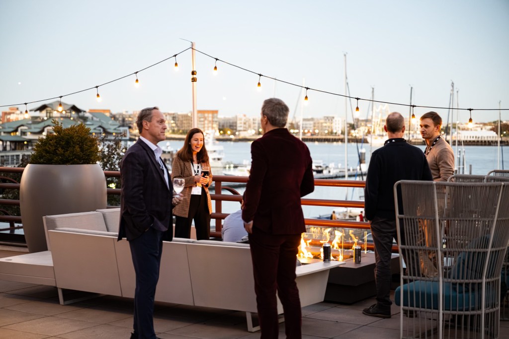 Outdoor networking at an Impact cocktail reception.
