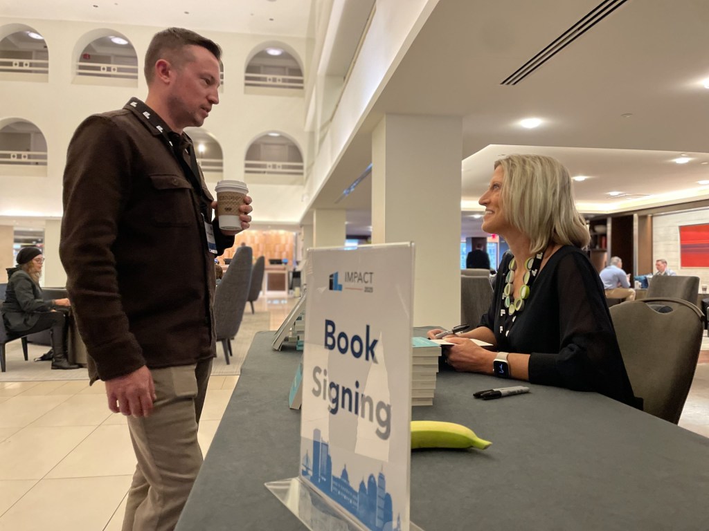 Robyn Bolton signs copies of her book “Unlocking Innovation.”