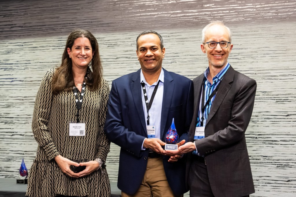 Award presenter Michelle Cohen of CME Group with winners Rahul Deshpande and Paul Konasewich of PACCAR, Inc.