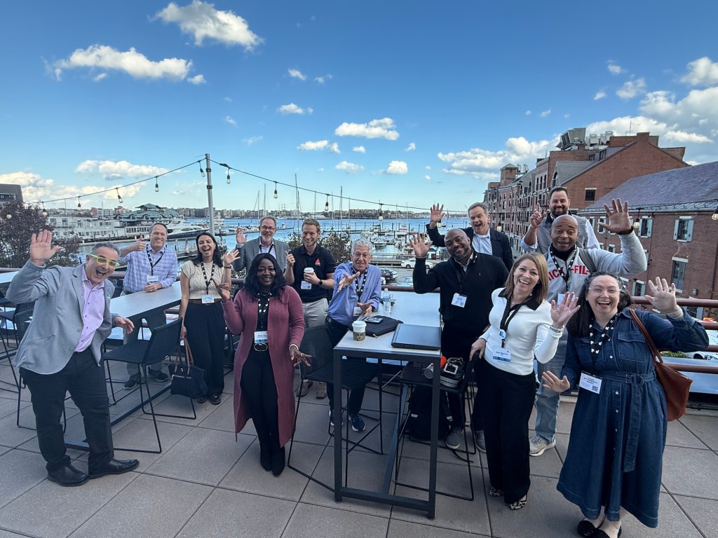 Impact participants gather on the outdoor deck at the end of the conference.