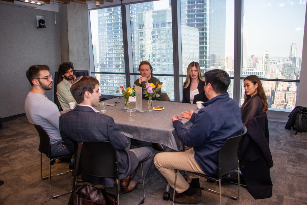 A group of attendees discuss generative AI and emerging technology in their organizations.