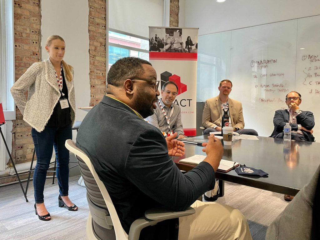 Parys Zambas of InnoLead looks on as William Singleton of Wrigley makes a point during a breakout discussion.