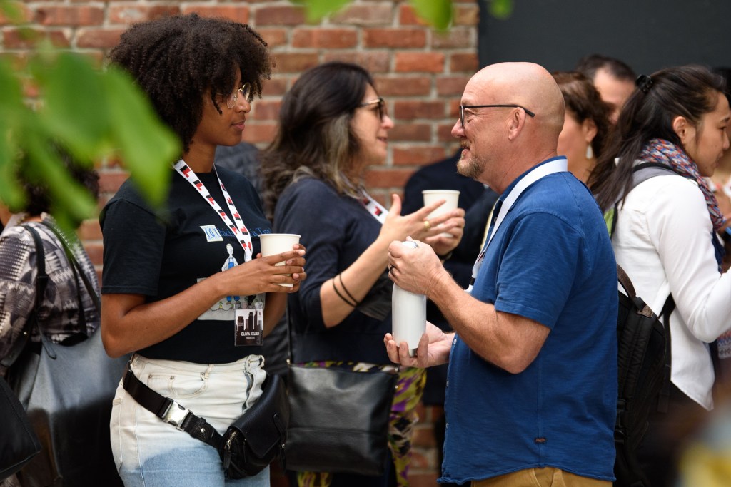 Olivia Keller, Product Manager at SmartOrg, and Lynn Shourds, Senior Vice President of Sales at InnovationCast, enjoy a networking break with coffee and conversation.