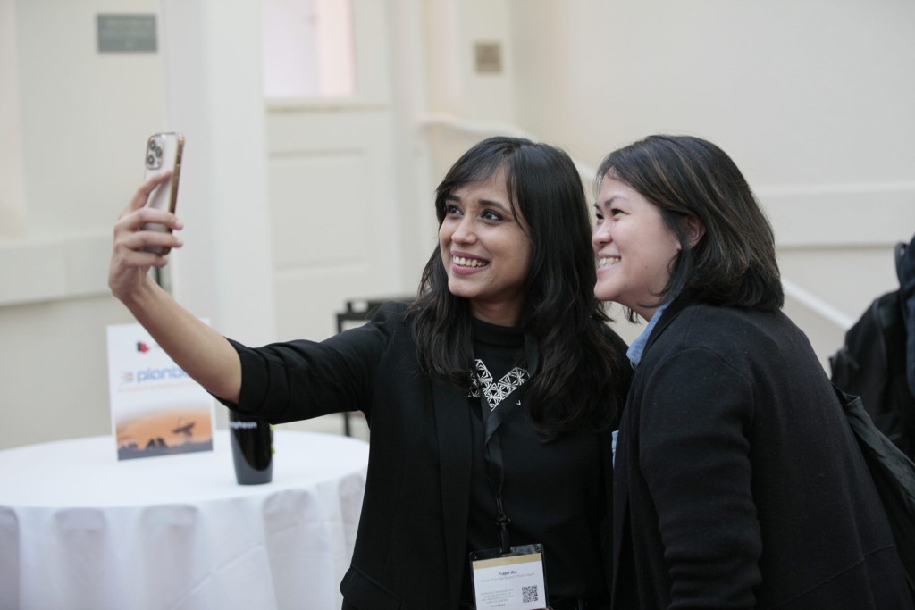 Prapti Jha of Harvard University and Jusien Yong of Edward Jones grab a photo together.