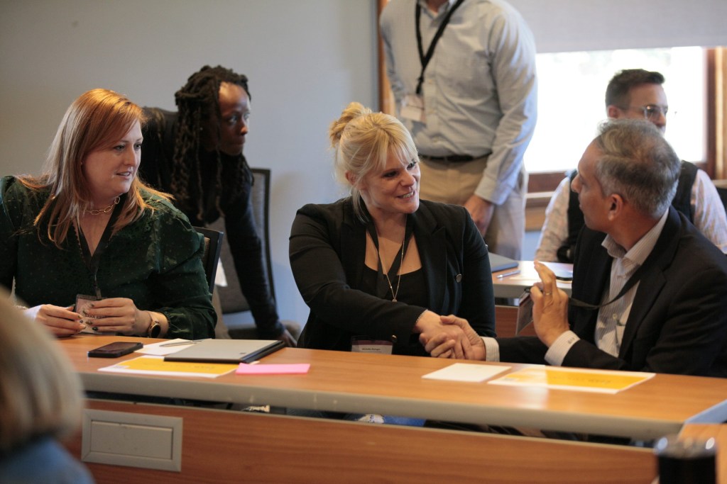 Sara Kraft of AstraZeneca, Michelle Risinger of Rising Solutions, and Amol Bargaje of Mayer Brown LLP introduce themselves during a breakout session.