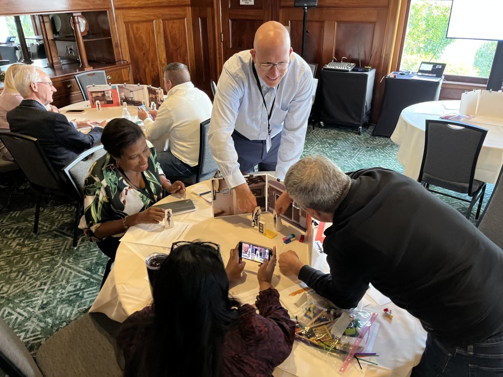 Attendees create videos with Legos and mini sets during a workshop on “tangible future scenarios,” led by Jill Lawrence, VP of Design at Crown Equipment Corporation.