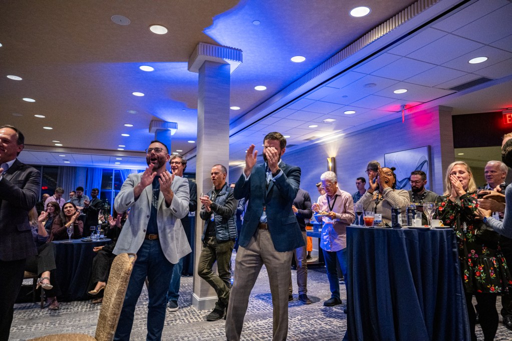 Audience members applaud for the winners.