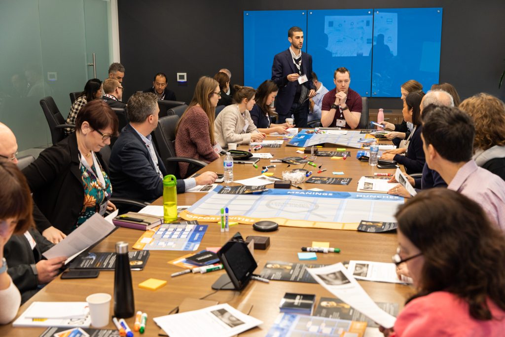 Attendees participate in an interactive innovation game lead by Planbox, one sponsor of the event.